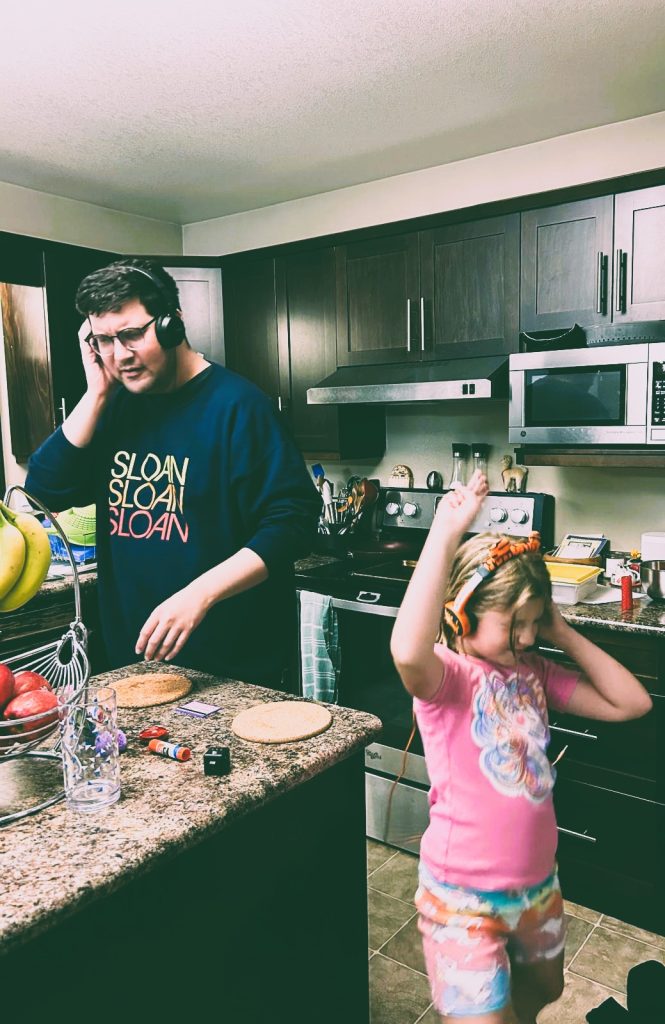 My daughter and I are partying in the kitchen, wearing headphones and pretending to be DJs.